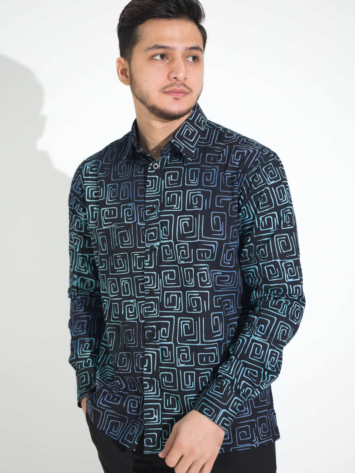 Gema GL913 long-sleeve batik shirt, black with teal and blue square spiral motif, close-up
