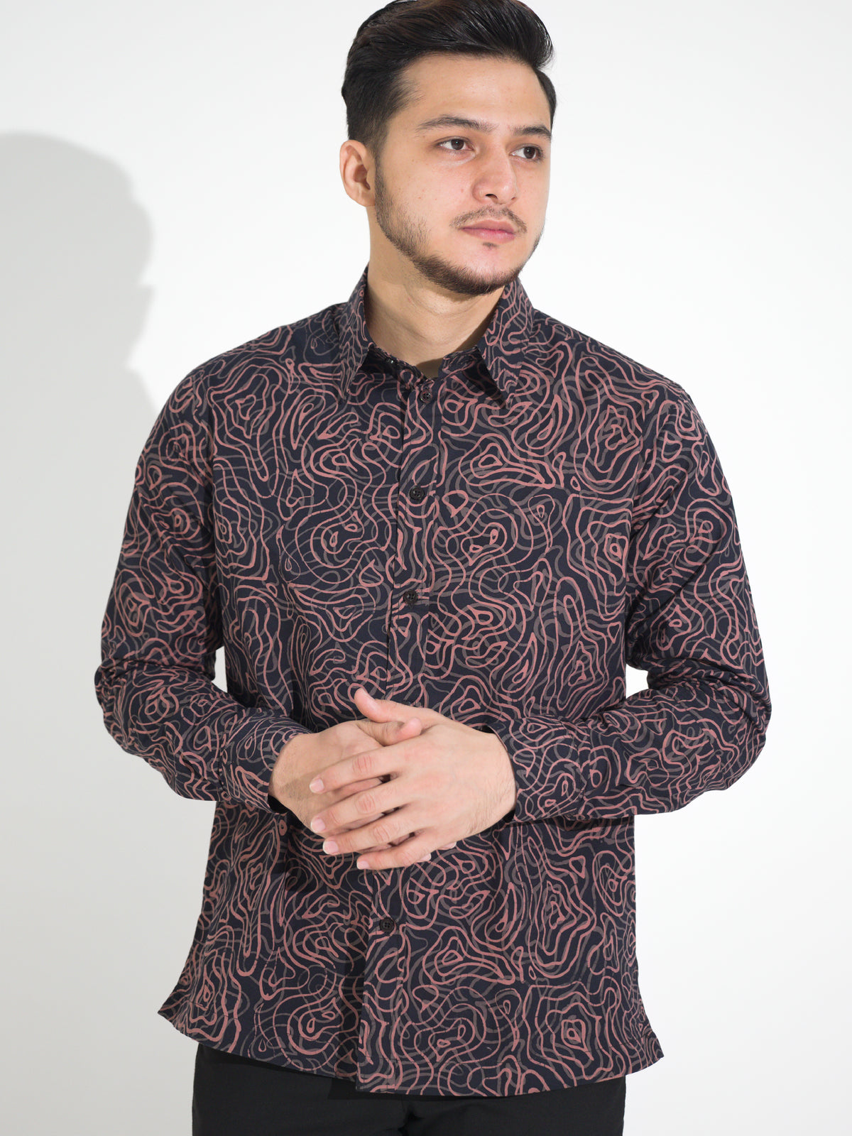 Ria RL902 long-sleeve batik shirt, black with pink flowing line motif, close-up