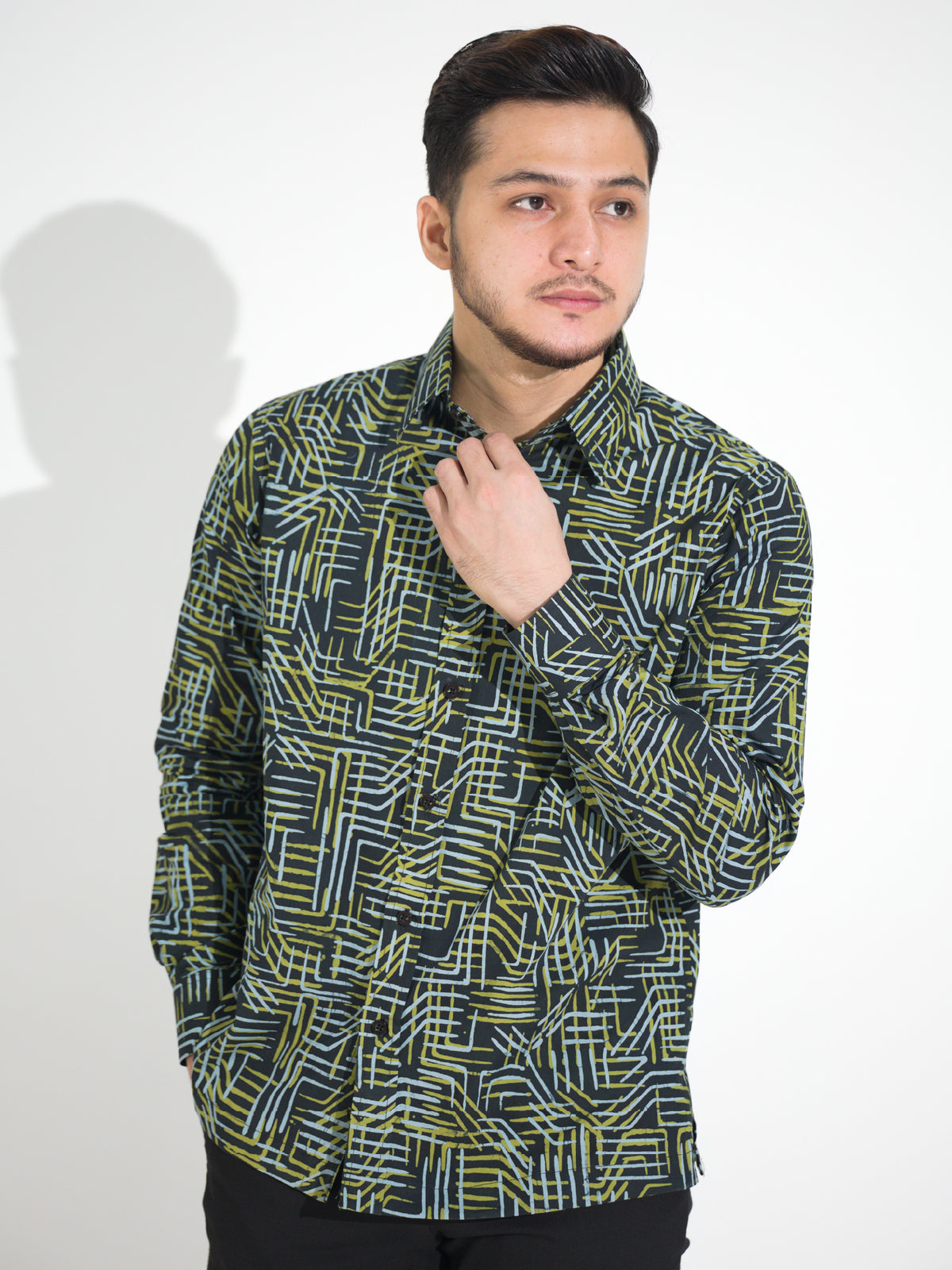 Ria RL903 long-sleeve batik shirt, black with green and white geometric line motif, close-up