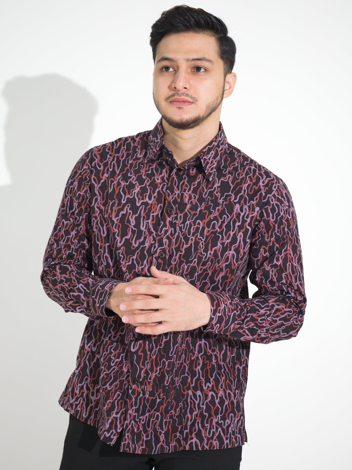 Ria RL905 long-sleeve batik shirt, black with red and pink wave motif, close-up